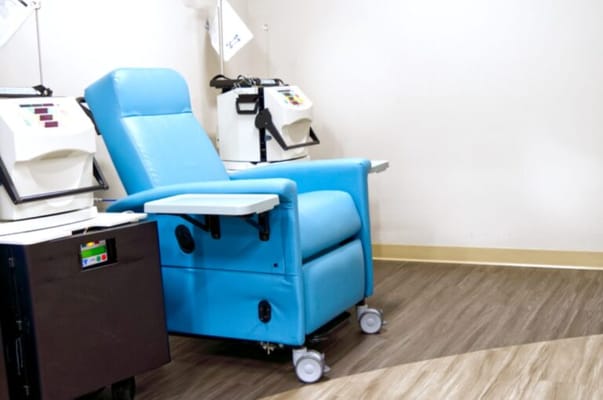 Blue recliner in a therapy room with medical equipment