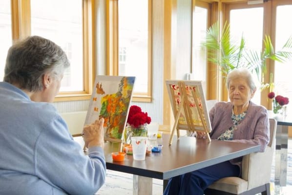 Residents engaging in a painting activity indoors