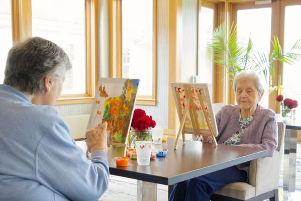Residents engaging in a painting activity indoors