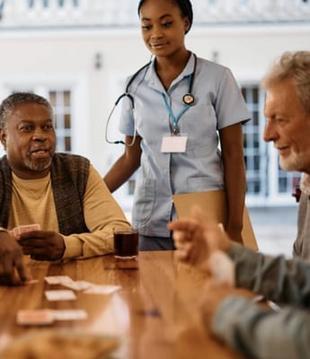 Residents playing cards in a cozy activity room