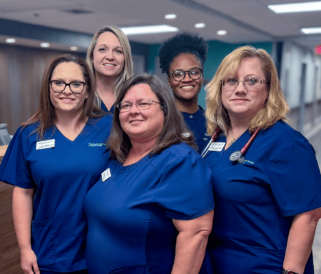 Group of staff members posing in the facility lobby