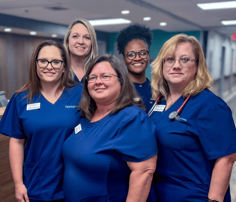 Group of staff members posing in the facility lobby