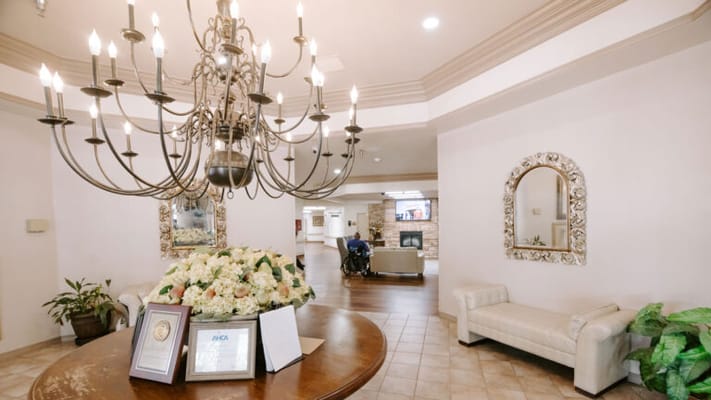 Common area lobby with floral arrangement and chandelier