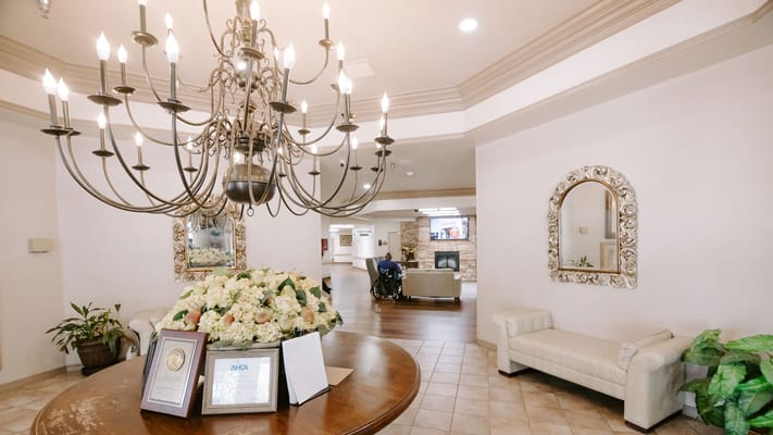 Common area lobby with floral arrangement and chandelier