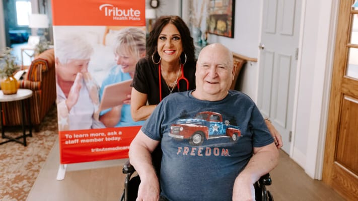 Resident and staff member smiling in a common area