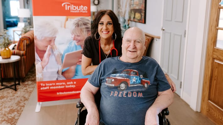 Resident and staff member smiling in a common area