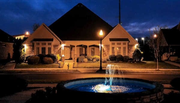 Exterior view of a senior living facility at night