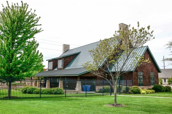 Exterior view of a senior living facility surrounded by greenery
