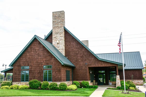 Exterior view of a senior living facility with landscaped entrance