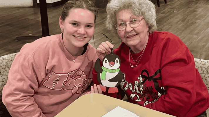 Resident and staff member enjoying craft time together