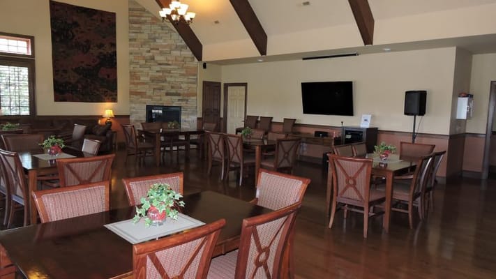 Cozy dining room area with wooden tables and chairs