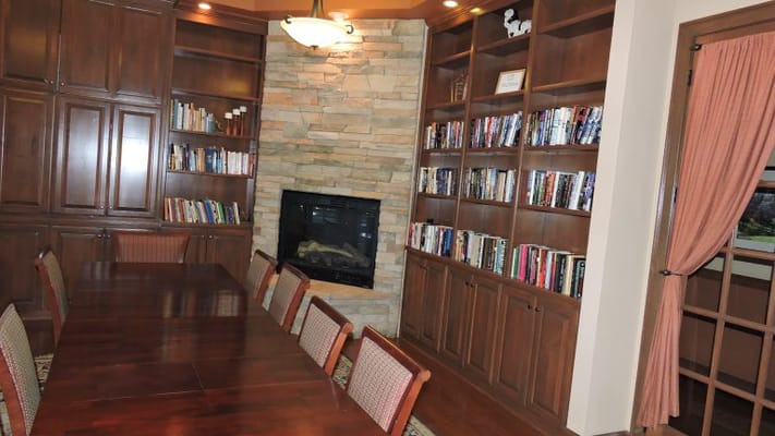 Interior view of a cozy reading room with shelves and seating