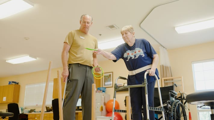 Staff assisting a resident in a therapy session