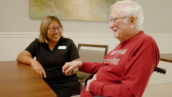 Staff member engaging with a resident in a common area