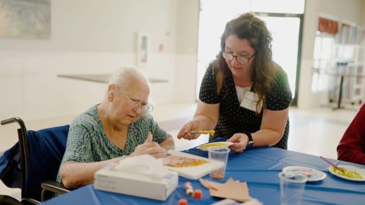 A resident engaged in an arts and crafts activity