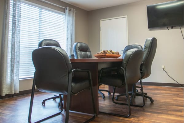 Conference room with a round table and leather chairs