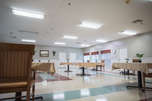 Dining area with tables and chairs in a bright setting