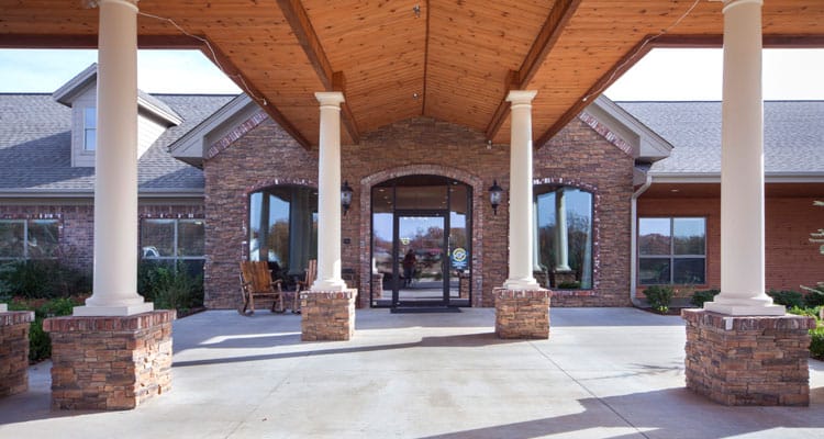 Entrance of a senior living facility with a covered porch