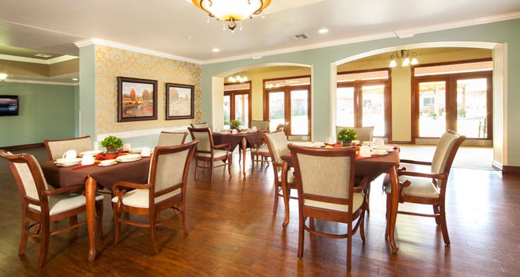 Dining area with neatly set tables and chairs