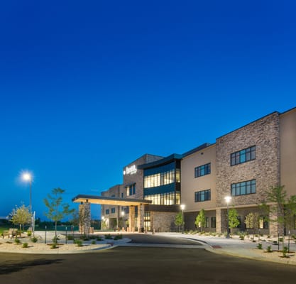 Exterior view of a senior living facility at dusk