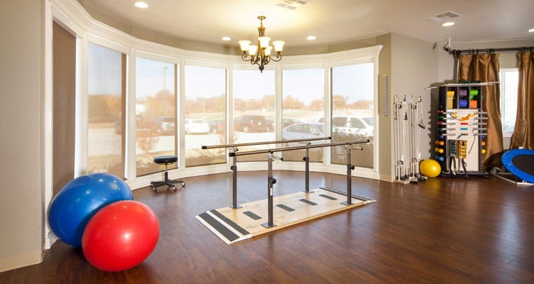 Rehabilitation room with exercise equipment and therapy bars