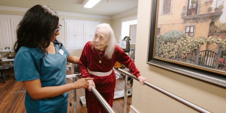 A staff member assisting a resident in a facility