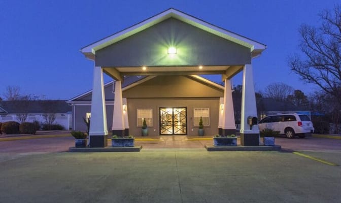 Front entrance of a senior living facility at dusk