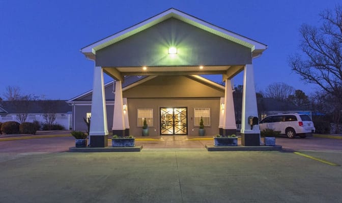 Front entrance of a senior living facility at dusk