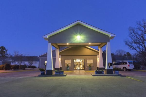 Front entrance of a senior living facility at dusk