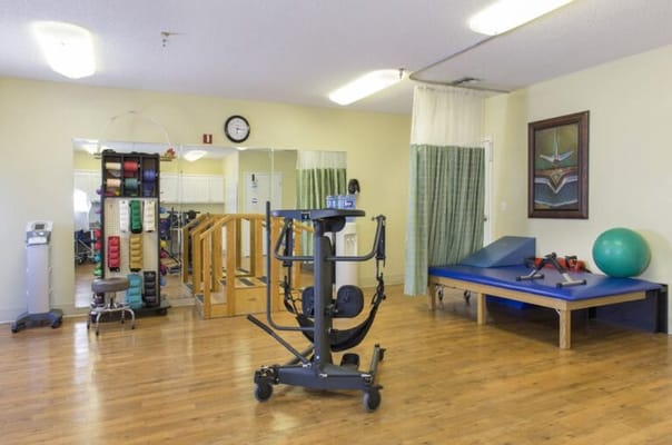 Interior view of a therapy room with exercise equipment