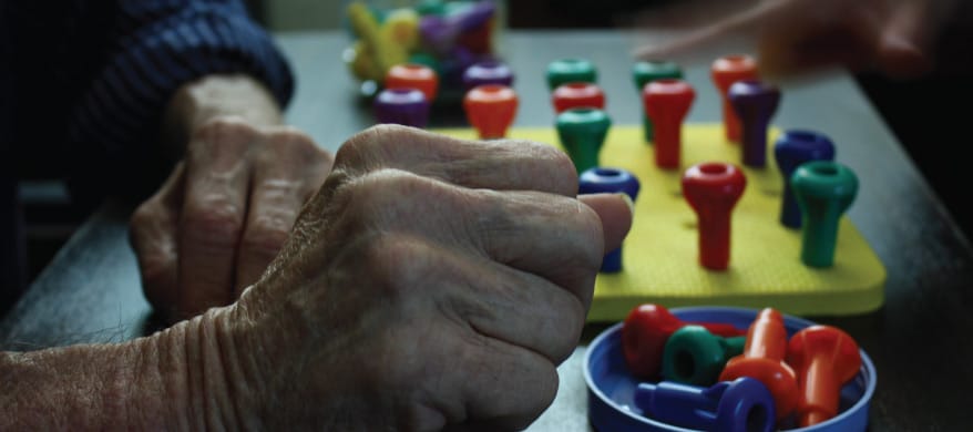 Hands of residents engaging in a colorful activity