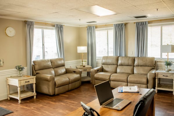 Cozy common area with leather seating and natural light