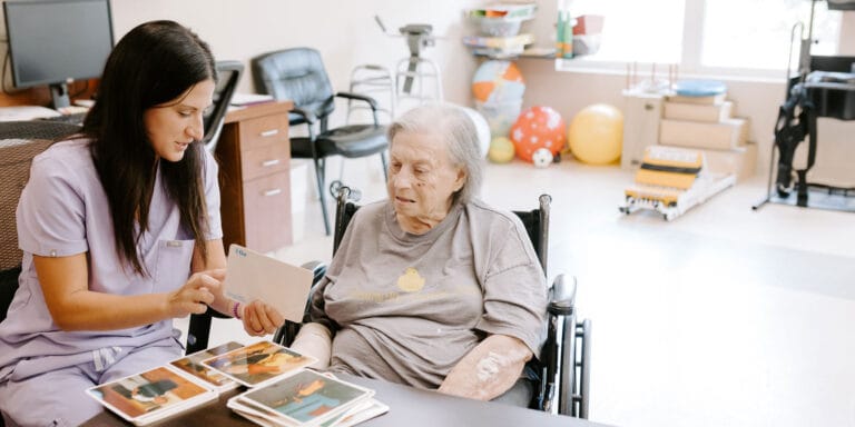 Caregiver assisting a resident with photos