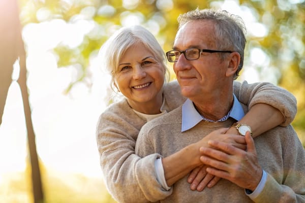 Happy couple enjoying time outdoors in a sunny park