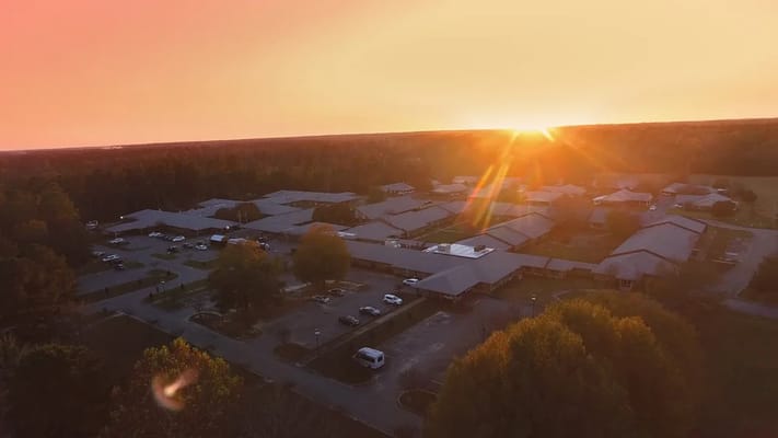 Aerial view of a senior living facility at sunset