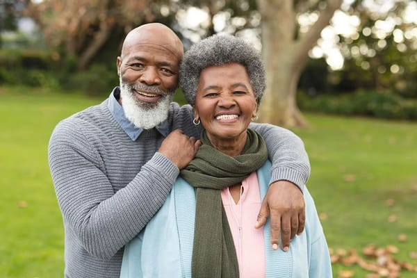 Happy senior couple smiling in a garden
