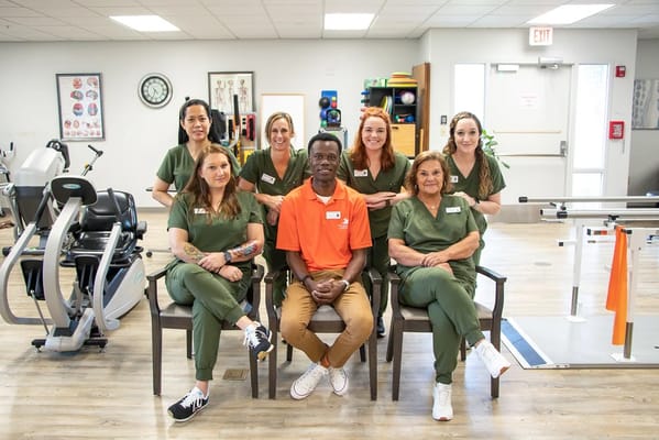 Staff members posing in a therapy room