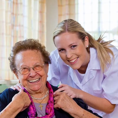 Caregiver with a smiling resident in a cozy interior