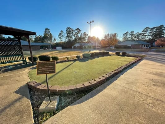 Outdoor space with landscaping and a sign