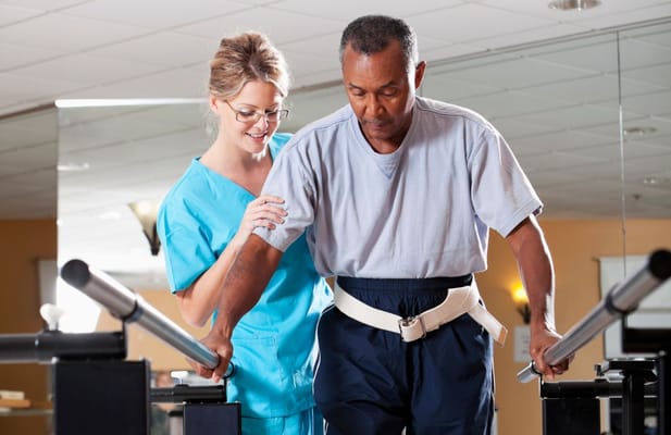 Therapist assisting a resident during rehabilitation