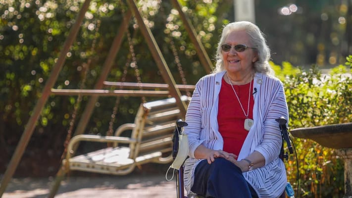 A resident enjoying time outside near a swing