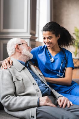 Nurse interacting with an elderly resident in a common area