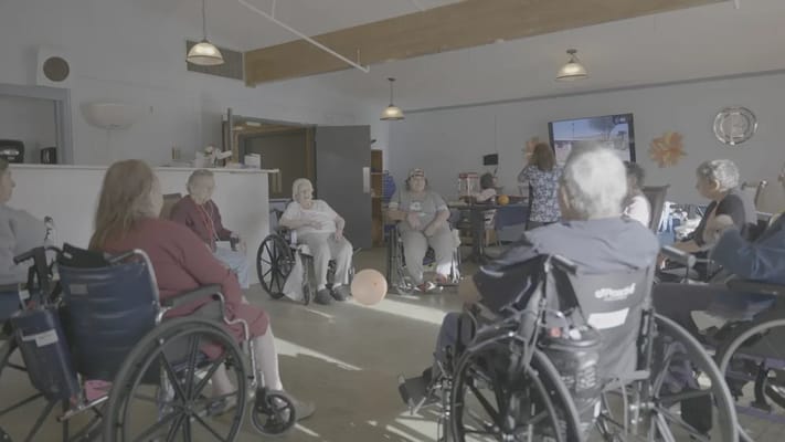 Residents participating in a group activity in a recreation room