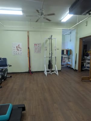 Interior view of a therapy room with workout equipment