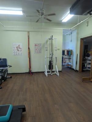 Interior view of a therapy room with workout equipment