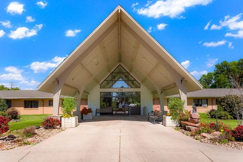 Front entrance of a senior living facility with landscaping