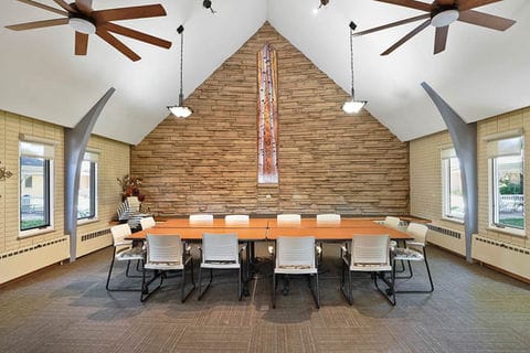 Bright common area with a large table and seating