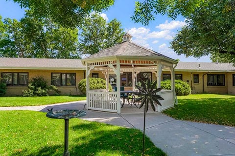 Gazebo in a green courtyard surrounded by buildings