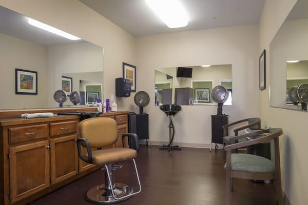 Hair salon setup with styling chairs and mirrors