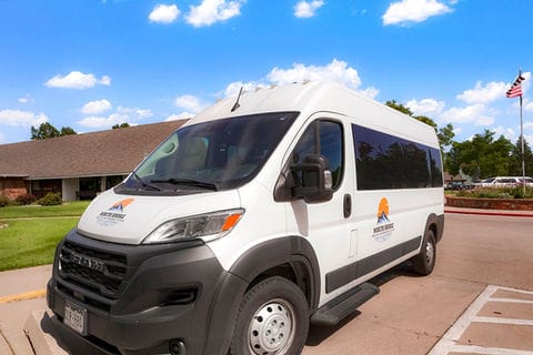 Facility van parked outside in a sunny area